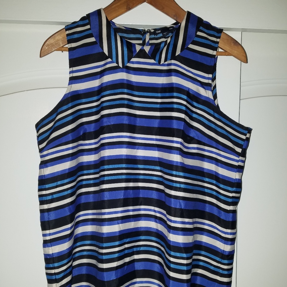 Blue, black and white stripped sleeveless shirt.